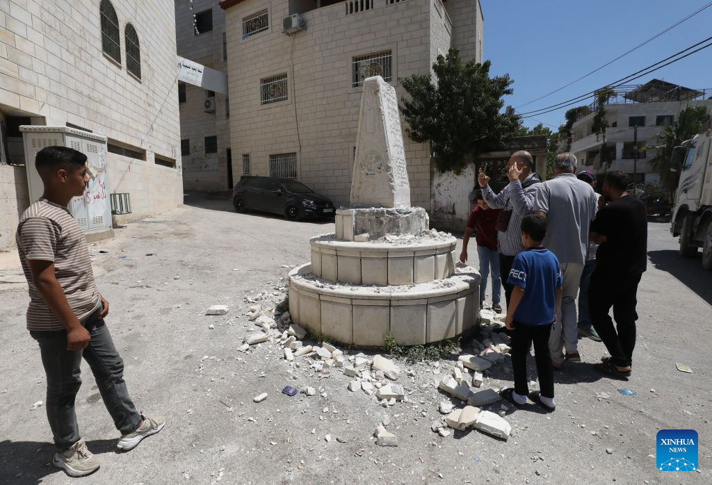 Palestinians inspect a Palestinian martyrs' memorial damaged by an Israeli settlers' attack, in Madma village in the West Bank city of Nablus, on Aug. 25, 2026. (Photo by Nidal Eshtayeh/Xinhua)