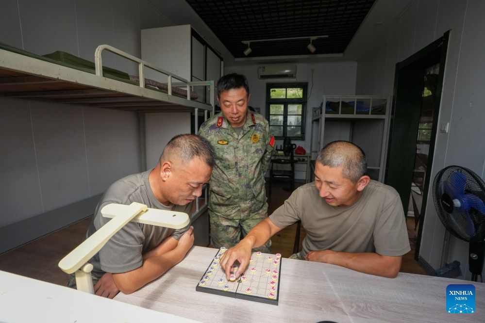 Militia members Liang Denggao (L), Sun Cundong (C) and Han Tongyong play chess during their spare time on Kaishan Island in east China's Jiangsu Province, Sept. 13, 2026. (Xinhua/Li Bo)
