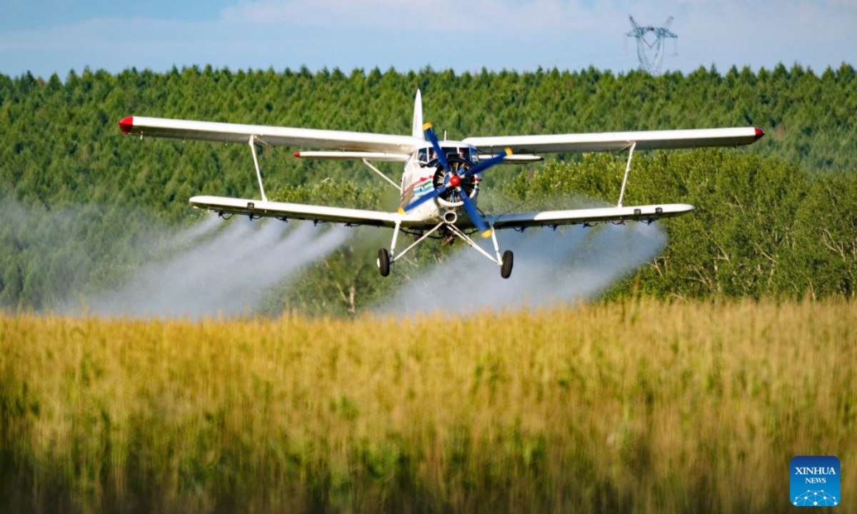 An agricultural plane carries out aerial crop protection operations over a corn field of Beidahuang Group in northeast China's Heilongjiang Province, July 28, 2026. Various agricultural production units under Beidahuang Group in Heilongjiang Province have launched aerial crop protection operations over farmlands in succession, safeguarding stable autumn grain production through scientific and technological methods. (Photo by Qian Boyu/Xinhua)