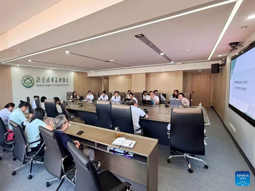 Lu Guijun and his hospice team carry out the hospice care grand rounds at a conference room of Beijing Tsinghua Changgung Hospital in Beijing, China, Sept. 21, 2026. (Xinhua)