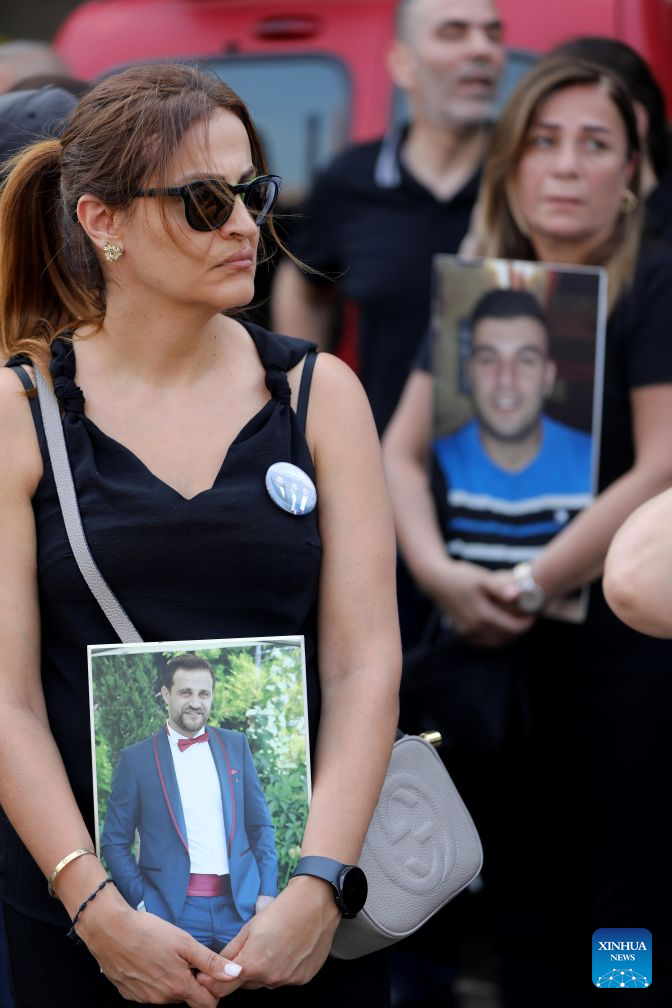 People hold portraits of the victims in commemoration of the sixth anniversary of the 2020 Beirut port blasts in Beirut, Lebanon, Aug. 4, 2026. (Xinhua/Bilal Jawich)