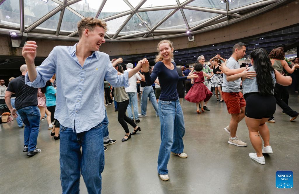People participate in the Sunday Afternoon Salsa and Bachata event at Robson Square in Vancouver, British Columbia, Canada, on Aug. 30, 2026. Hundreds of people of different ages took part in the annual Sunday Afternoon Salsa and Bachata event here on Sunday. The outdoor event brought together dance enthusiasts and beginners to enjoy Latin-style music and dancing. (Photo by Liang Sen/Xinhua)