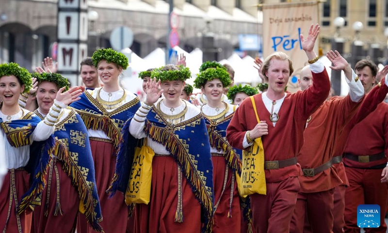 Participants in traditional costumes attend a parade of the Gaudeamus Baltic Student Song and Dance Festival in Riga, Latvia, June 21, 2026. Thousands of university students from Latvia, Lithuania, and Estonia gathered in the Latvian capital to participate in Gaudeamus, the milestone cultural event, celebrating youth and Baltic traditions. (Photo by Edijs Palens/Xinhua)