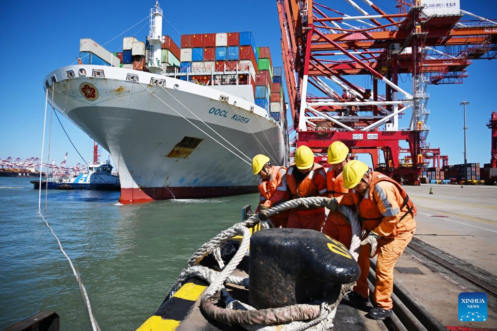 Workers untie the mooring lines of a cargo ship at Qingdao Port in Qingdao, east China's Shandong Province, Oct. 8, 2026. As an international shipping hub in Northeast Asia, Qingdao Port has been expanding its shipping network, adding 16 foreign trade routes so far this year. The port now operates nearly 240 foreign trade routes, connecting over 700 ports in over 180 countries and regions. (Xinhua/Li Ziheng)