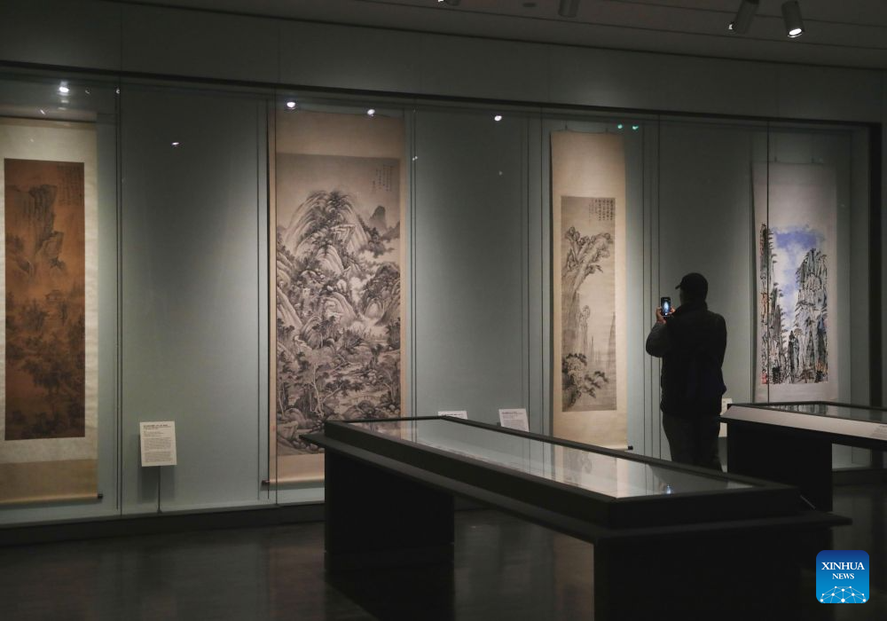 A visitor takes photos of an exhibit at an exhibition named The Mountains of the Mind: A Chinese Landscape Journey at the Asian Art Museum in San Francisco, the United States, Sept. 19, 2026. The exhibition, featuring over 20 paintings, runs from December 13, 2025 to October 26, 2026. (Photo by Liu Yilin/Xinhua)