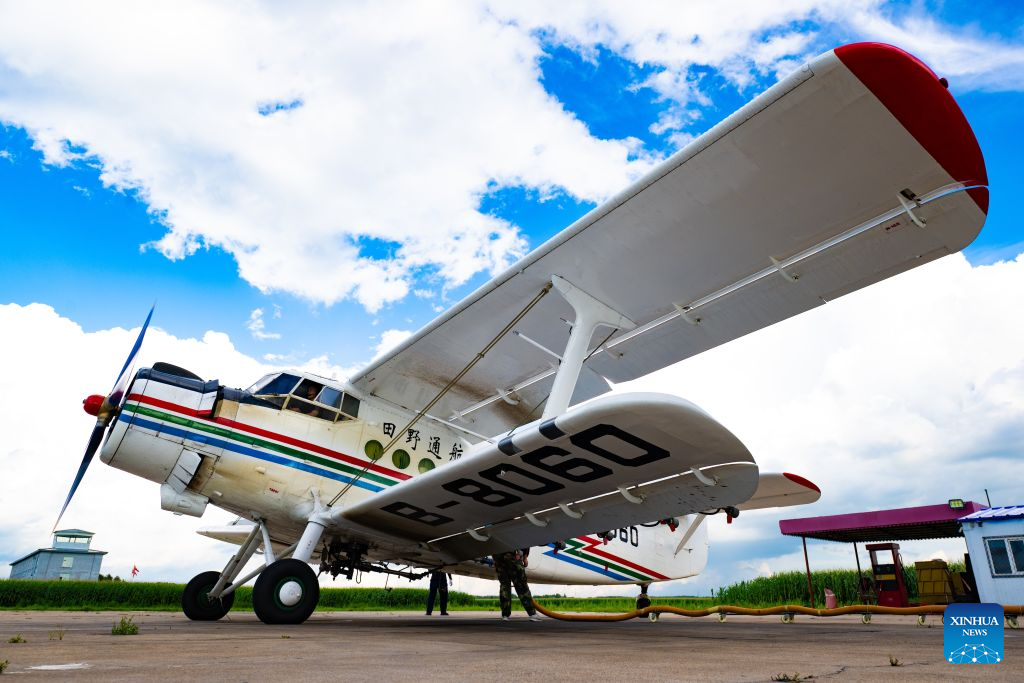 Staff members prepare an agricultural plane for aerial operations at an airport of Beidahuang Group in northeast China's Heilongjiang Province, July 28, 2026. Various agricultural production units under Beidahuang Group in Heilongjiang Province have launched aerial crop protection operations over farmlands in succession, safeguarding stable autumn grain production through scientific and technological methods. (Photo by Qian Boyu/Xinhua)