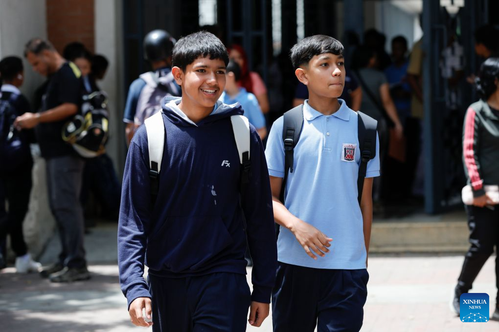Students are pictured near a school, in Caracas, Venezuela, Sept. 14, 2026. More than 6 million Venezuelan students began the new school year on Monday, including those in La Guaira state in the country's north, which was hard hit by earthquake. (Photo by Marcos Salgado/Xinhua)