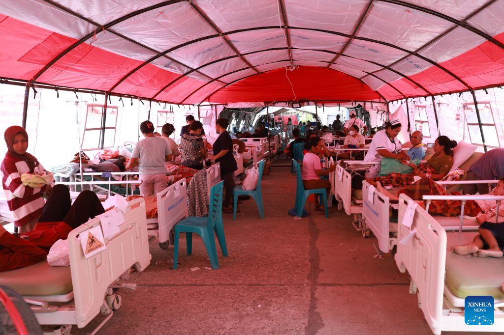 Patients and their relatives rest at an emergency tent outside Komodo Regional Hospital, East Nusa Tenggara Province, Indonesia, Aug. 17, 2026. The death toll from a 7.7-magnitude earthquake that struck Indonesia's East Nusa Tenggara (NTT) province has risen to 68, the National Disaster Management Agency (BNPB) said Monday. (Indonesia's Ministry of Health/Handout via Xinhua)