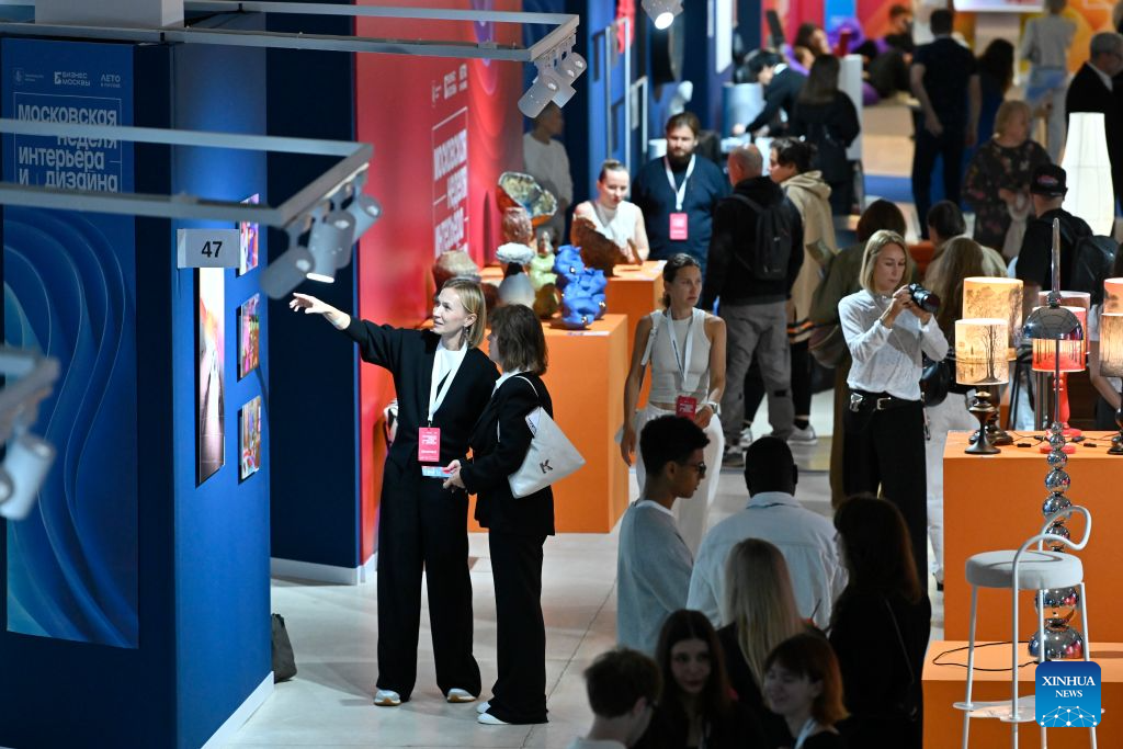Visitors view interior design works displayed at the Manege Central Exhibition Hall in Moscow, Russia, on Aug. 13, 2026. The 8th Moscow Interior and Design Week kicked off at the Manege Central Exhibition Hall here on Thursday. Under the theme Infinite Colours, the event draws participation from about 1,300 Russian and foreign brands and will run until Aug. 16. (Photo by Alexander Zemlianichenko Jr/Xinhua)