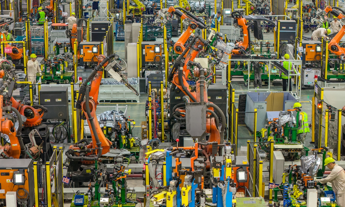 Industrial robot production lines run at full capacity at a new-energy vehicle (NEV) parts company in Jinhua, East China's Zhejiang Province on June 22, 2026, as workers race to process orders for NEV components. Data from the National Bureau of Statistics showed that NEV production reached 1.489 million units in May, up 17.8 percent year-on-year. Photo: VCG