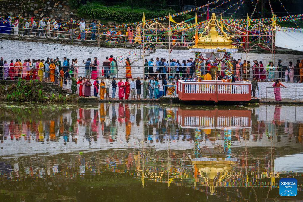 People attend the celebration of Nag Panchami, a Hindu festival dedicated to the worship of snakes, on Nagdaha Lake in Lalitpur, Nepal, Aug. 17, 2026. (Photo by Hari Maharjan/Xinhua)