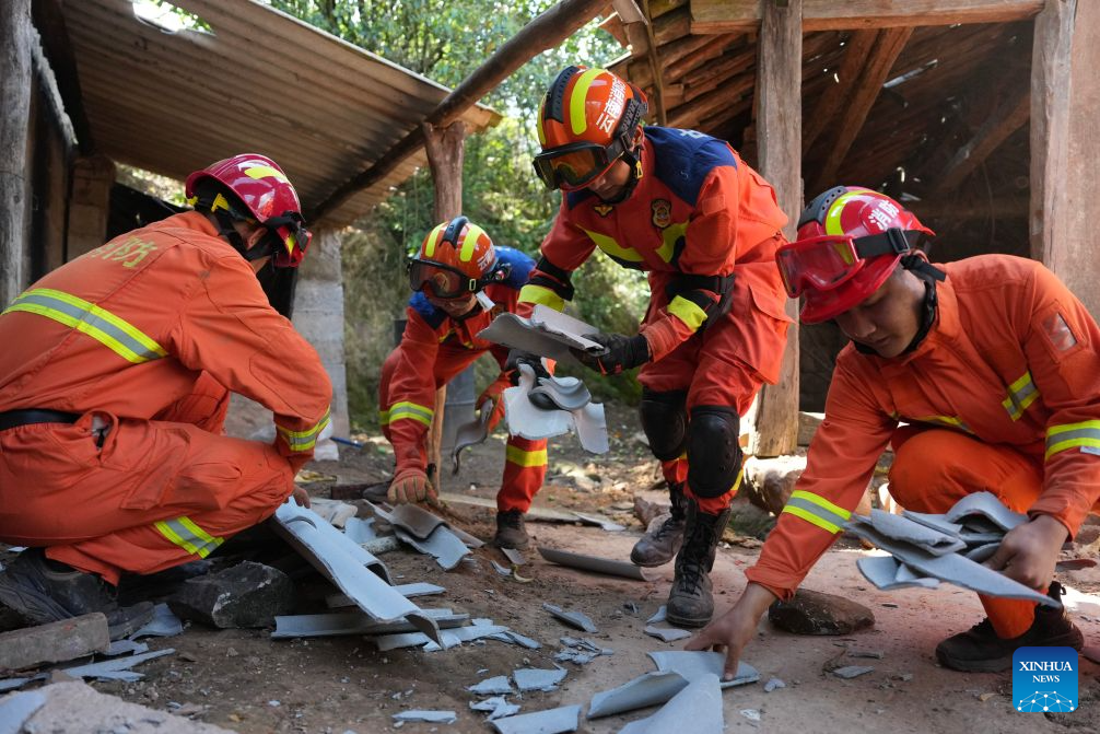 Firefighters clear debris at Jingping Village in Yutang Town of Mojiang Hani Autonomous County, southwest China's Yunnan Province, on July 22, 2026. The Yunnan provincial earthquake relief headquarters has activated a Level-IV emergency response after a 5.0-magnitude earthquake jolted Mojiang on Tuesday, local authorities said. No casualties have been reported so far. (Xinhua/Chen Xinbo)