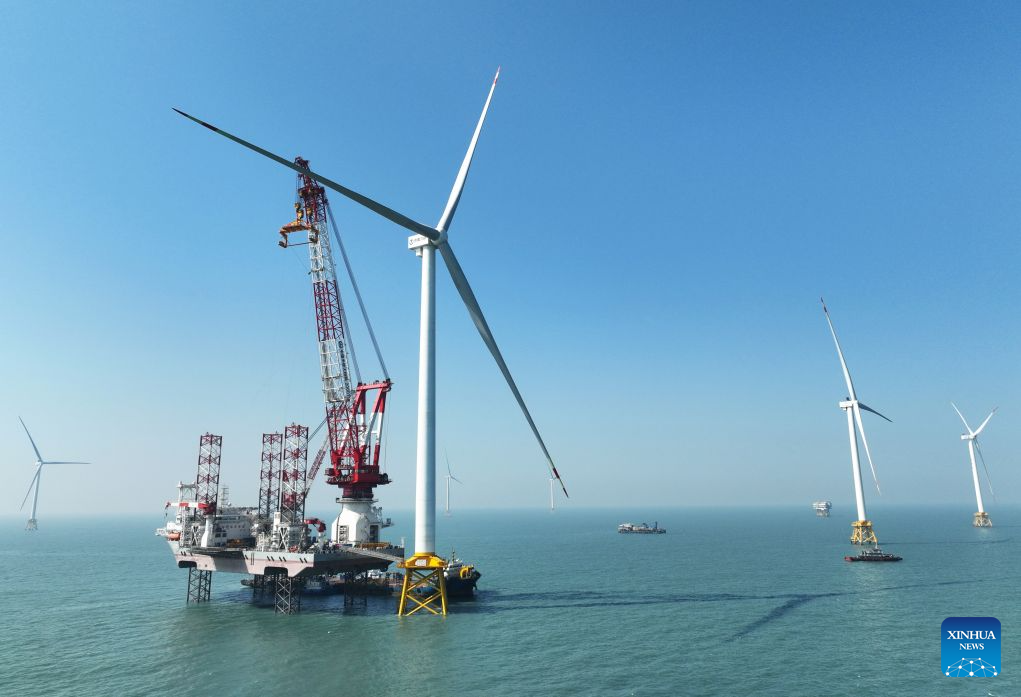 A drone photo taken on Jan. 13, 2026 shows part of an offshore wind farm and a 2,000-ton jack-up offshore wind turbine installation platform on the waters of southern Fujian in southwest China. The province of Fujian is rich in high-quality clean energy resources like wind power, solar energy, hydro power and nuclear power. In recent years, Fujian has relied on its local clean energy endowment and geographical advantages to build its smart new power grids and develop the region as a major clean energy hub in southeast China. It has accelerated the construction of power transmission channels, steadily upgraded urban and rural distribution networks, promoted the construction of smart micro-grids, continuously revitalized its clean energy advantages, and consolidated the foundation of energy security through the construction of smart new power grids. (Xinhua/Lin Shanchuan)