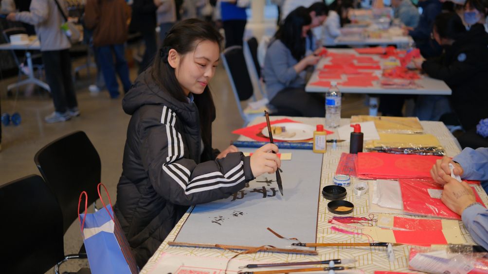 A student practices Chinese calligraphy before a gala celebrating Mid-Autumn Festival and Chinese National Day at the Australian National University in Canberra, Australia, on Sept. 5, 2026. The event was held here on Saturday, featuring performances of songs, dances and instruments. A range of traditional Chinese cultural activities, including Chinese calligraphy, Hanfu experiences and lacquer fan making, were also held before the gala. (Photo by Zhang Na/Xinhua)