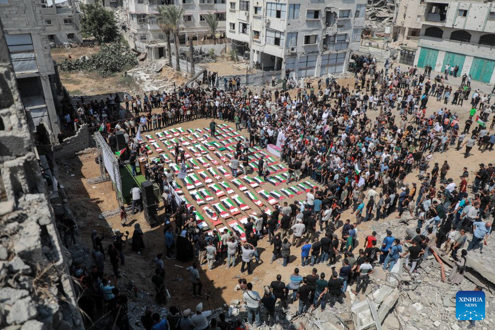 Palestinians attend the mass funeral of 112 victims in Gaza City on Aug. 4, 2026.
The funeral came after the remains of the victims were recently recovered from beneath the rubble of houses destroyed in an Israeli airstrike in November 2023. (Photo by Rizek Abdeljawad/Xinhua)