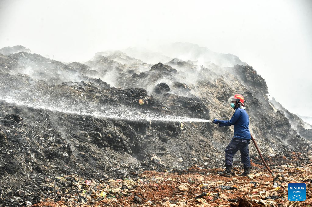 A firefighter attempts to put out a fire at the smoldering landfill in Tangerang Regency, Banten Province, Indonesia, on July 2, 2026. A fire broke out at a landfill in Tangerang regency, near the Indonesian capital city of Jakarta, on Tuesday, scorching more than two hectares of land, local officials said. (Xinhua/Agung Kuncahya B.)