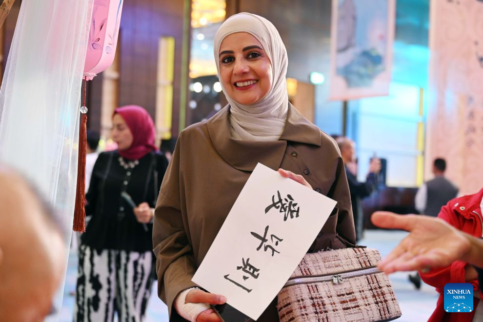 A woman is pictured during a cultural event showcasing the traditions and tourism resources of north China's Hebei Province in Farwaniya Governorate, Kuwait, Sept. 19, 2026. The event kicked off here on Saturday evening, drawing more than 300 guests. (Photo by Asad/Xinhua)
