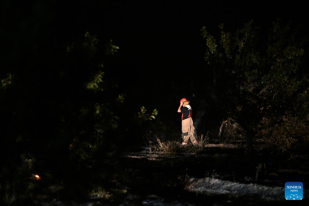 A firefighter is seen in an operation to control a spreading wildfire fueled by weeks of extreme summer heat and dry vegetation in Strumica, North Macedonia, Aug. 22, 2026. (Photo by Tomislav Georgiev/Xinhua)