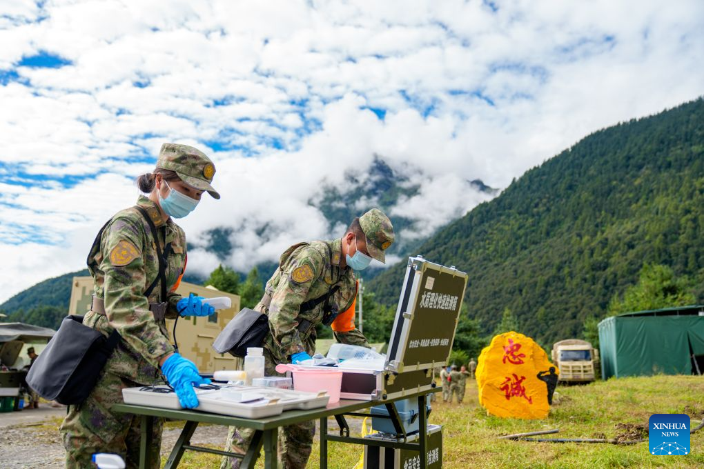 Military health workers check water quality in Gyirong Town, southwest China's Xizang Autonomous Region, Sept. 1, 2026. Health workers from the Xizang military authority carried out on-site medical rounds and disinfection on Tuesday to ensure fundamental medical needs of the rescuers and the locals. (Xinhua/Tenzin Nyida)