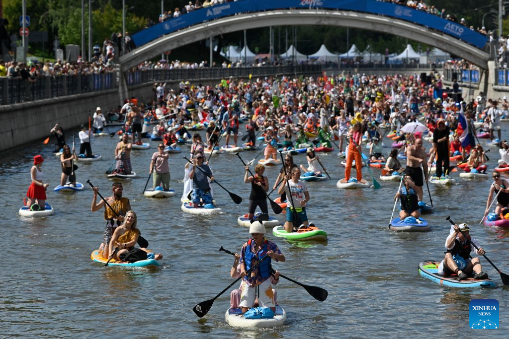 People take part in the annual Yauzafest paddleboarding festival in Moscow, Russia, on Aug. 9, 2026. (Photo by Alexander Zemlianichenko Jr/Xinhua)