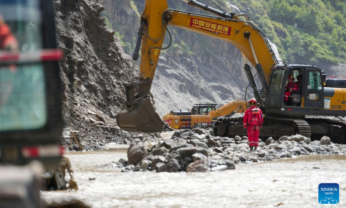 This photo shows a road clearance operation underway in a section of the G216 national highway from Gyirong Town to Gyirong Port in southwest China's Xizang Autonomous Region, on Aug. 30, 2026. China Anneng, a state-owned engineering and rescue enterprise, continued its rescue work on Sunday in an attempt to restore the last few kilometers of damaged section of the G216 national highway leading to Gyirong Port. (Xinhua/Jigme Dorje)