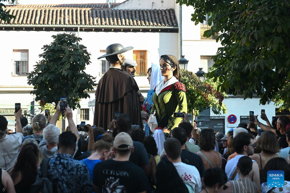 People enjoy a parade held during the San Cayetano Festival in Madrid, Spain, Aug. 4, 2026. (Photo by Gustavo Valiente/Xinhua)