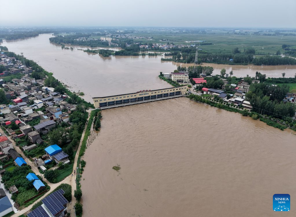 An aerial drone photo taken on Aug. 13, 2026 shows a flood discharge scene at the Nihewa flood storage and detention area in Wuyang County of Luohe City, central China's Henan Province. Affected by Typhoon Dolphin, the 13th typhoon of the year, the Shaying River has recorded a flow rate exceeding 3,000 cubic meters per second in its Luohe section, while the water level continues to rise. In accordance with relevant contingency plans, Henan Province activated the Nihewa flood storage and detention area on Thursday. (Xinhua/Hao Yuan)