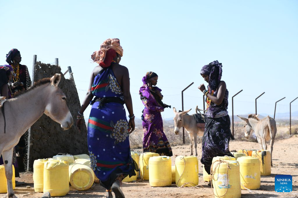 Villagers feed water to donkeys at a village in the Chalbi Desert, Marsabit County, Kenya, on July 15, 2026. Marsabit County features contrasting landscapes: the dry Chalbi Desert and green, lake-strewn Marsabit National Park. (Xinhua/Liu Qiong)