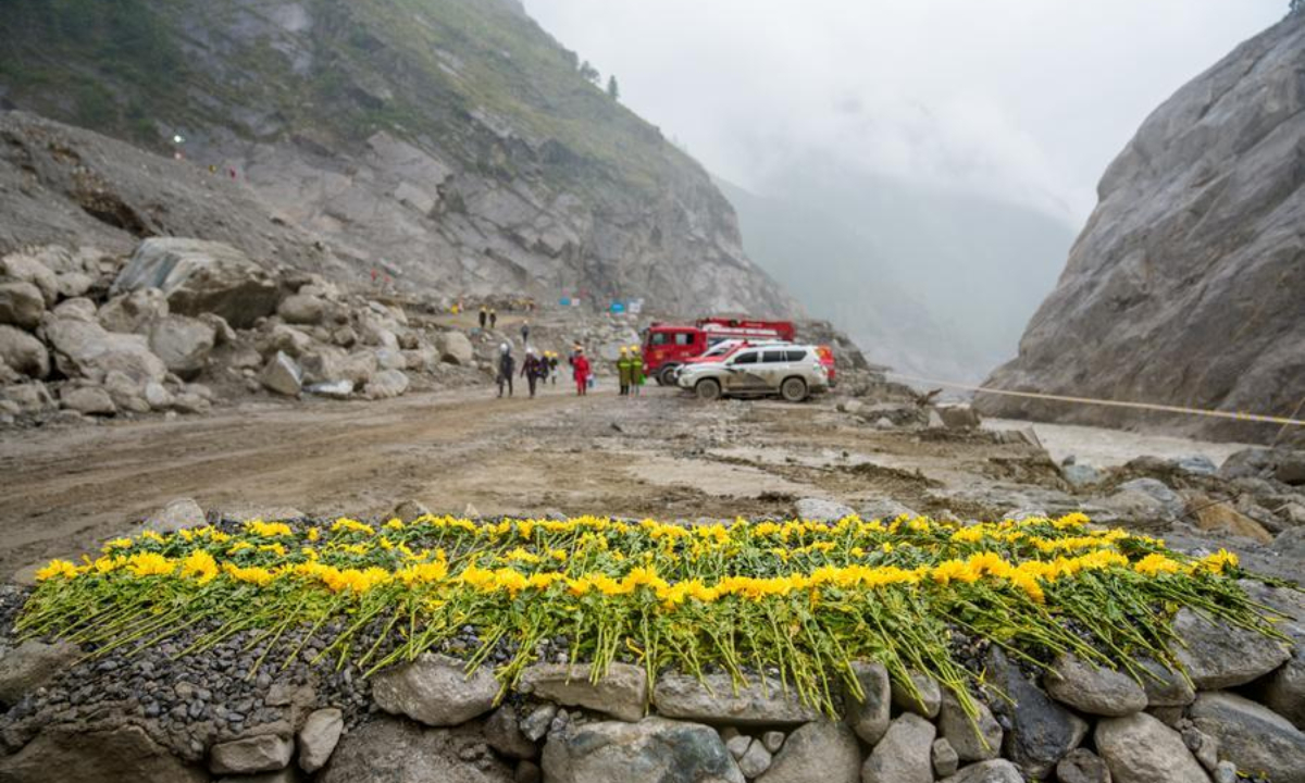 Flowers are laid at the core affected zone of the mudslide-hit Gyirong Port in southwest China's Xizang Autonomous Region, Sept. 6, 2026. (Xinhua/Tenzin Nyida)