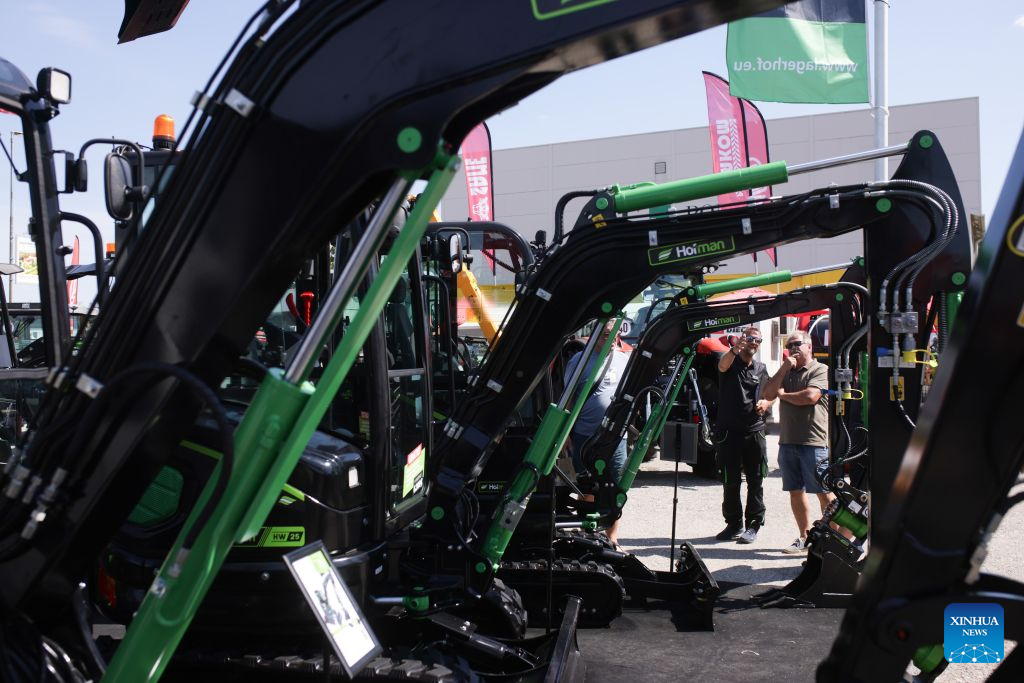People observe agricultural machinery on display during the 64th International Fair of Agriculture and Food (AGRA) in Gornja Radgona, northeast Slovenia, Aug. 24, 2026. (Photo by Zeljko Stevanic/Xinhua)