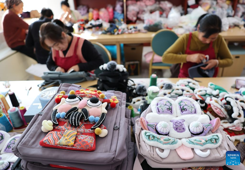 Workers make handicrafts at a workshop in Yuanzhou District, Guyuan City of northwest China's Ningxia Hui Autonomous Region, Sept. 21, 2026. Yuanzhou District in Guyuan City has developed an integrated model combining intangible cultural heritage, original design and e-commerce, encouraging local businesses to develop original Duoxiu embroidery patterns and expand handicraft markets. The district has established 12 community handicraft workshops, creating jobs for more than 3,600 people and turning traditional skills into economic opportunities. (Xinhua/Liu Yun)