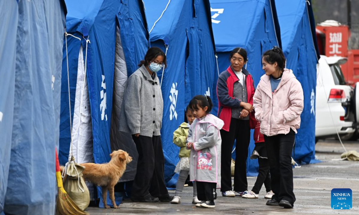 Villagers chat at a temporary relocation site in Madang Town, Xiahe County of the Tibetan Autonomous Prefecture of Gannan, northwest China's Gansu Province, July 16, 2026. Severe convective weather triggered mountain torrents here from July 13 to 14. Two temporary relocation sites were set up in Madang Town to accommodate 107 affected residents. (Xinhua/Fan Peishen)