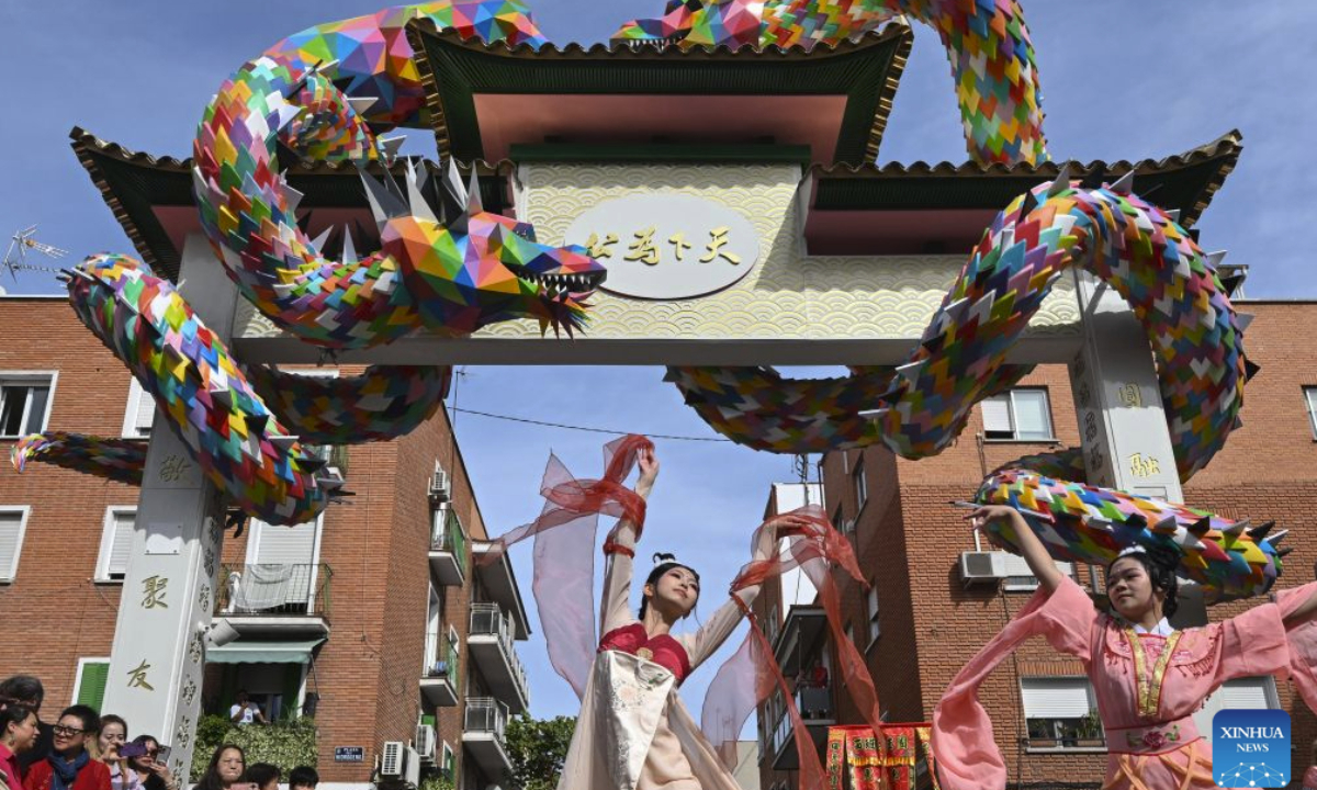 People dance during the unveiling ceremony of the Chinese archway in Usera district of Madrid, Spain, Oct. 1, 2026. A Chinese archway featuring two dragons and Madrid's emblematic bear was unveiled Thursday in the Usera district of the Spanish capital, celebrating the neighborhood's cultural diversity and the ties with its Chinese community. (Xinhua/Cheng Min)