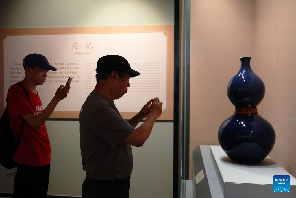 People visit the exhibition titled A Nation in Treasures: Selected Masterpieces Marking the Centenary of the Shenyang Imperial Palace Museum at Shenyang Palace Museum in Shenyang, northeast China's Liaoning Province, Aug. 11, 2026. The exhibition revisits the museum's 100-year history through 100 exhibits in multiple categories, and is expected to run until the end of the year. (Xinhua/Li Gang)