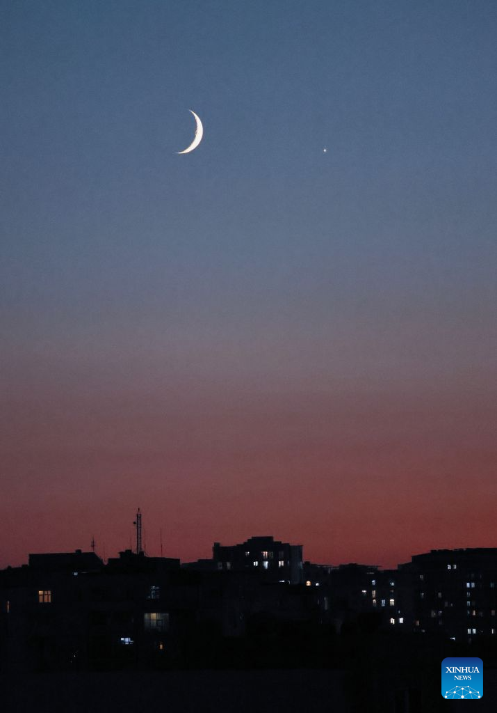 This photo taken on Sept. 14, 2026 shows the planet of Venus next to the moon in the twilight sky over Baku, Azerbaijan. (Xinhua/Chen Junfeng)