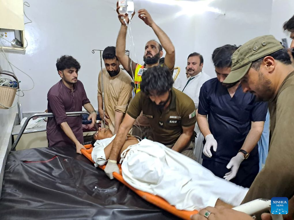 Rescuers transfer an injured man in Khyber Pakhtunkhwa province, Pakistan, Aug. 2, 2026. The death toll from a suicide blast near a peace rally in Pakistan's northwestern Khyber Pakhtunkhwa province has risen to 14, while 26 others were injured, police sources told Xinhua on Sunday. (Str/Xinhua)