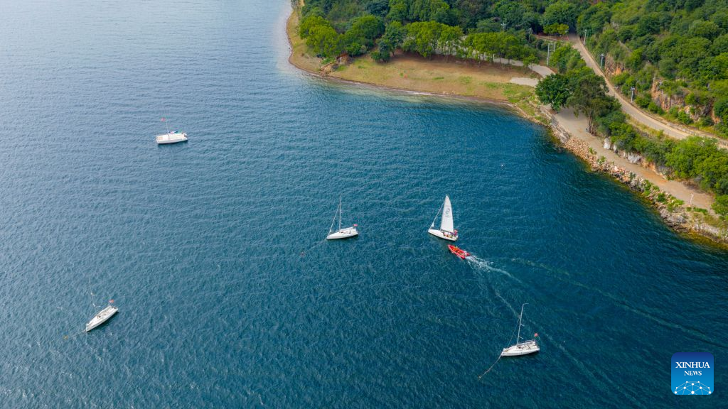 An aerial drone photo taken on Sept. 14, 2026 shows the scenery of a scenic area on the west bank of Fuxian Lake in Yuxi City, southwest China's Yunnan Province. In recent years, local authorities have stepped up efforts to protect ecological environment of Fuxian Lake and developed more lakeside activities, combining the natural scenery with local fishing culture to create more consumption experiences. (Xinhua/Hu Chao)