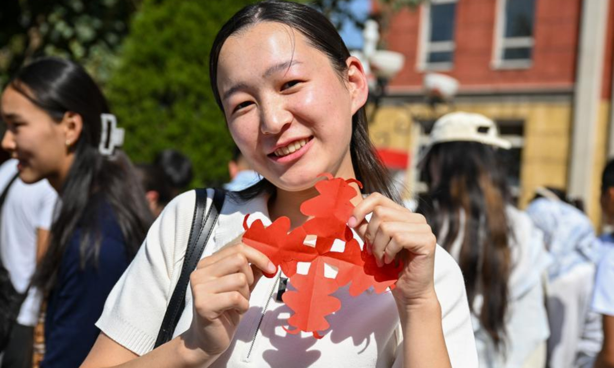A student shows a paper-cutting work at the Confucius Institute at the Osh State University in Osh, Kyrgyzstan, Sept. 22, 2026. (Xinhua/Ding Lei)
