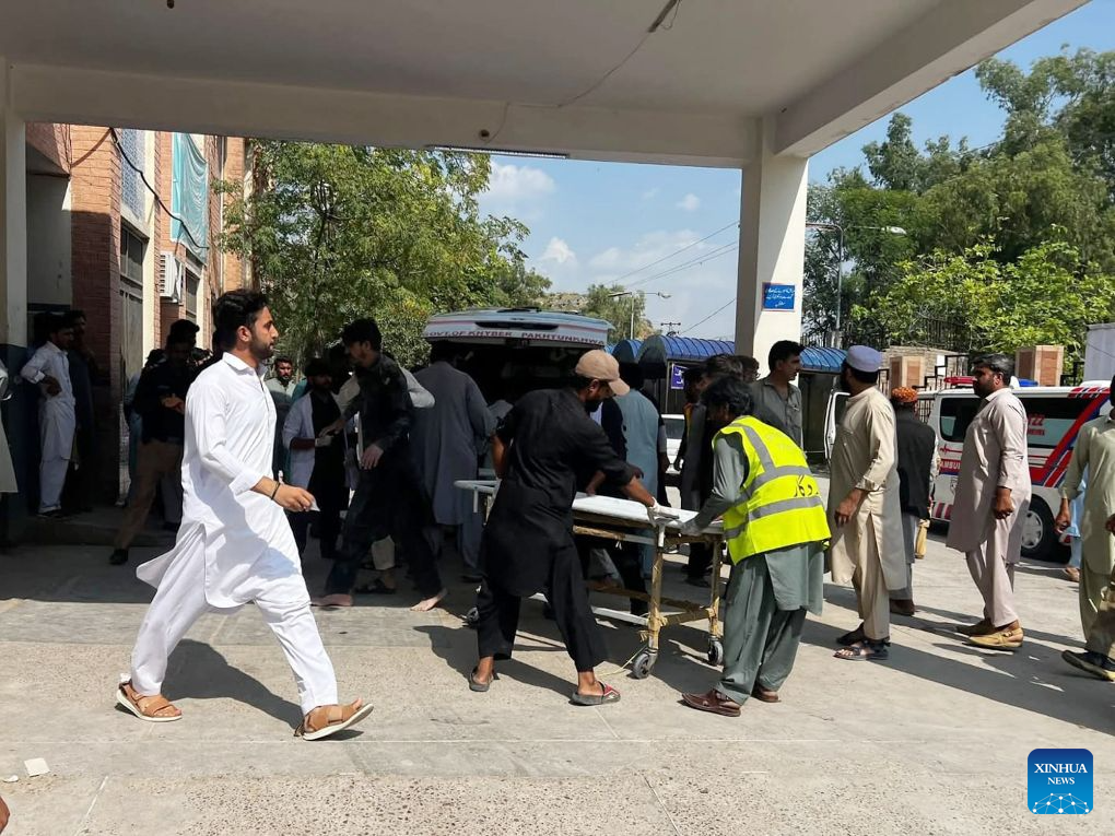 This photo taken with mobile phone shows rescuers transferring injured people to the hospital at Kohat in Pakistan's Khyber Pakhtunkhwa province on Sept. 18, 2026. At least 16 people were killed and over 50 others injured in a twin suicide attack inside a residential compound of police in Pakistan's Khyber Pakhtunkhwa province on Friday, police and rescue officials said. (Str/Xinhua)