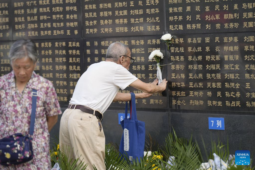 A citizen places flowers near the name of his relative on a memorial wall inscribed with names of the victims at the Tangshan Earthquake Memorial Park in Tangshan, north China's Hebei Province, July 28, 2026. This year marks the 50th anniversary of the Tangshan Earthquake, a magnitude-7.8 quake that struck the city on July 28, 1976, taking the lives of more than 240,000 people and destroying virtually all buildings in the city.

Crowds of people visited the Tangshan Earthquake Memorial Park on Tuesday to mourn and remember the victims in the devastating disaster. (Photo by Zhao Liang/Xinhua)
