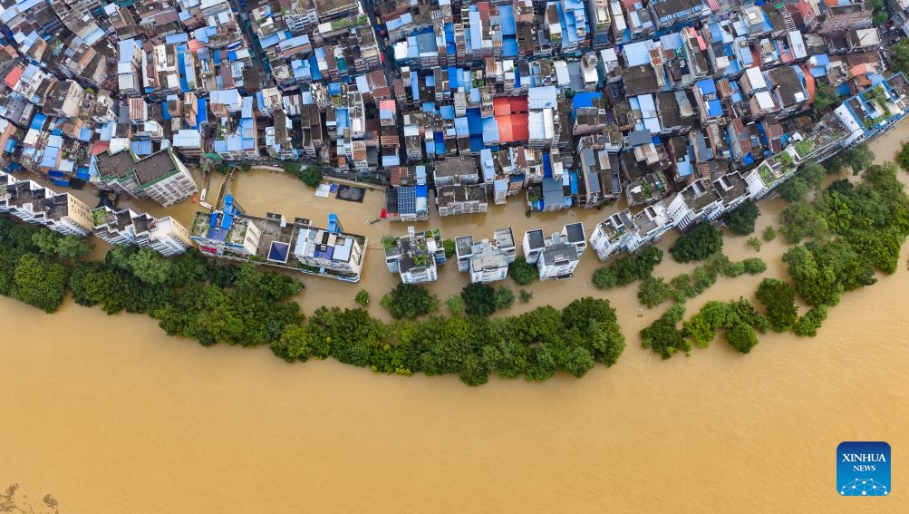 An aerial drone photo taken on June 22, 2026 shows the flood peak passing through the Liujiang River in Liuzhou, south China's Guangxi Zhuang Autonomous Region. Due to heavy rainfall, the Liuzhou hydrological station on the Liujiang River recorded the first flood peak of 2026 on Monday, with the highest water level reaching 85.64 meters, exceeding the alert line by 3.14 meters while flooding some riverfront roads. (Photo: Xinhua)