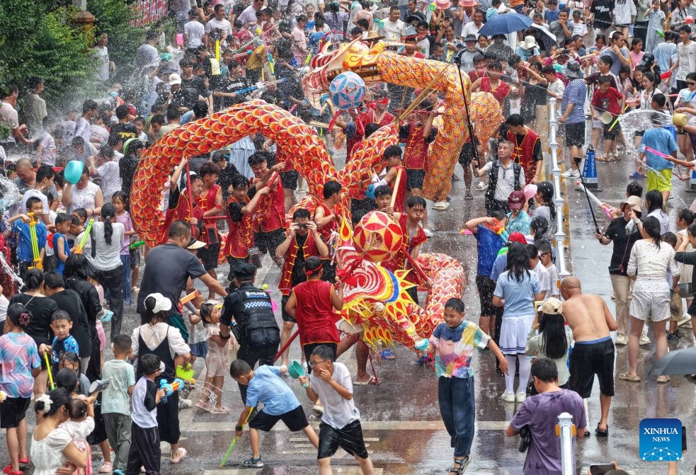 People participate in a water-splashing event to celebrate the Dragon Boat Festival in Shibing County, Qiandongnan Miao and Dong Autonomous Prefecture, southwest China's Guizhou Province, June 20, 2026. People enjoyed the three-day holiday of the Dragon Boat Festival, also called Duanwu Festival, which falls on June 19 this year, via various activities across the country. (Photo: Xinhua)