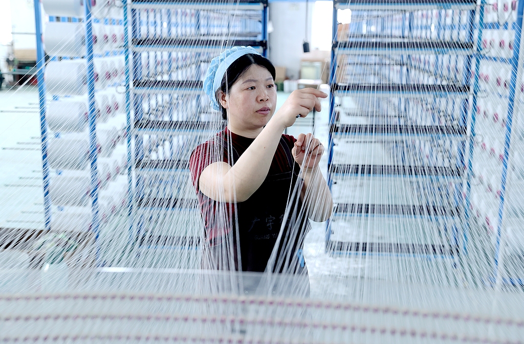 Workers step up production to meet order deadlines at a textile firm in Caoji Township, Suqian City, East China's Jiangsu Province, on June 24, 2026. In recent years, the township government has delivered targeted services, including policy support, resource matchmaking, and talent recruitment, to boost the growth potential and competitiveness of local enterprises, allowing local residents to find jobs right at their doorsteps. Photo: VCG