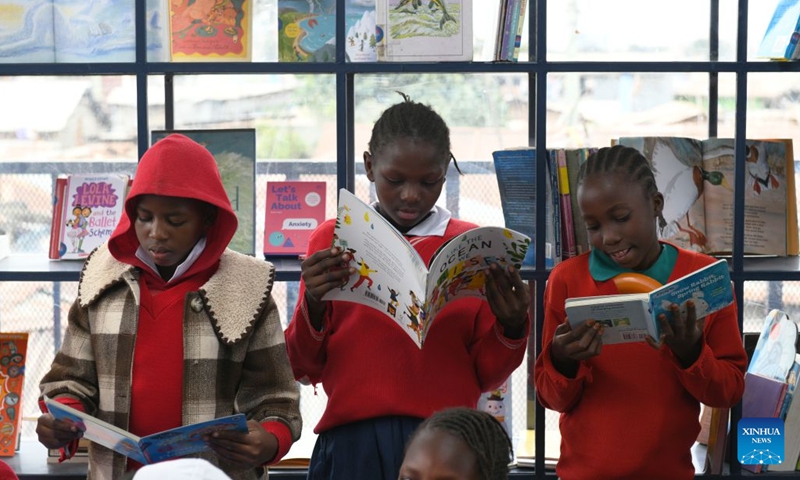 Children read books inside the Amani Kibera Book House in the Kibera slum of Nairobi, the capital of Kenya, on June 23, 2026. A completion ceremony for the Amani Kibera Book House, a public welfare library designed by an architectural research team from the Chinese University of Hong Kong, was held in Nairobi on Tuesday. (Photo: Xinhua)