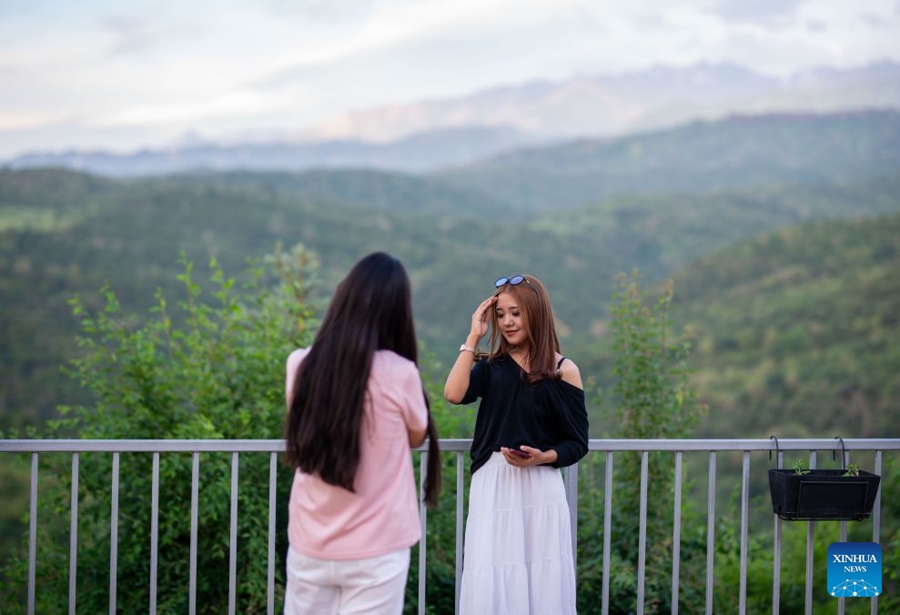 People take pictures on the Koktobe Mountain in Almaty, Kazakhstan on June 22, 2026. (Photo: Xinhua)