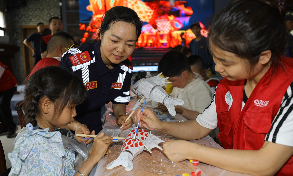 Children with rare diseases learn to make fish-shaped lanterns at a scenic spot in Huangshan, East China's Anhui Province, on May 26, 2026. Photo: VCG