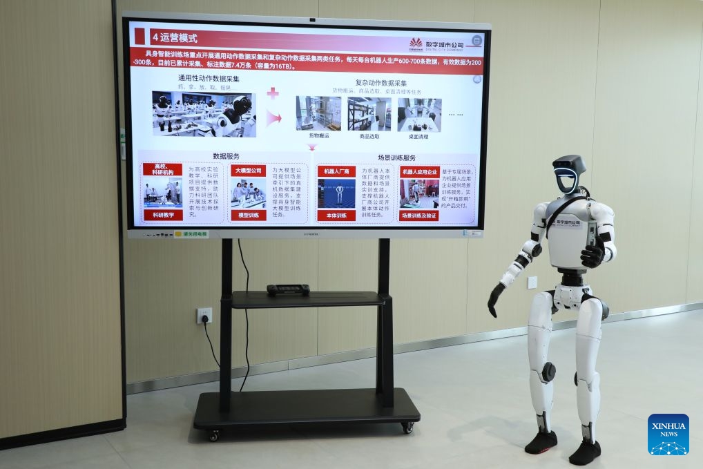 A humanoid robot presents an introduction at a training center for embodied AI in Xiong'an, north China's Hebei Province, June 23, 2026. Xiong'an in Hebei Province has established a training center for embodied AI tailored to various scenarios since December 2025. Equipped with simulated workshops replicating real-world environments, massive amounts of robots' data are generated, making embodied AI increasingly smart and capable of service in all walks of life. (Photo: Xinhua)