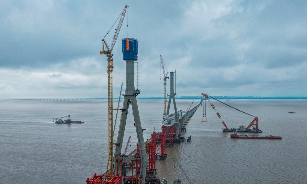 Workers complete the concrete pouring of the main tower of the South Channel Bridge of the Hangzhou Bay Cross-Sea Railway Bridge amid rain in Hangzhou, East China's Zhejiang Province on June 24, 2026. The 29.2-kilometer-long Hangzhou Bay Cross-Sea Railway Bridge is a crucial segment of the Nantong-Suzhou-Jiaxing-Ningbo High-Speed Railway, according to the Xinhua News Agency. Photo: VCG