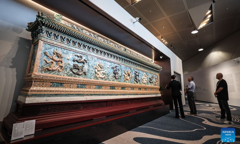 Guests admire a shell carving work at the Dalian International Conference Center, venue of the 2026 Summer Davos forum, in Dalian, northeast China's Liaoning Province, June 23, 2026. The World Economic Forum's Annual Meeting of the New Champions, also known as the Summer Davos forum, is held in the port city of Dalian from June 23 to 25. An exhibition is open to visitors at the Dalian International Conference Center, featuring more than 1,300 works from 54 forms of intangible cultural heritage. (Photo: Xinhua)
