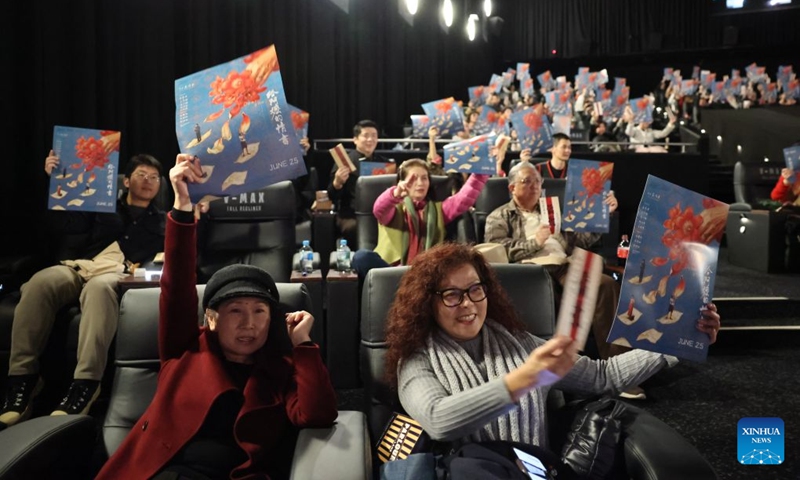 Audiences take photos with posters of Chinese film Dear You during its premiere in Sydney, Australia, June 23, 2026. The film will be released in Australia on June 25. (Photo: Xinhua)